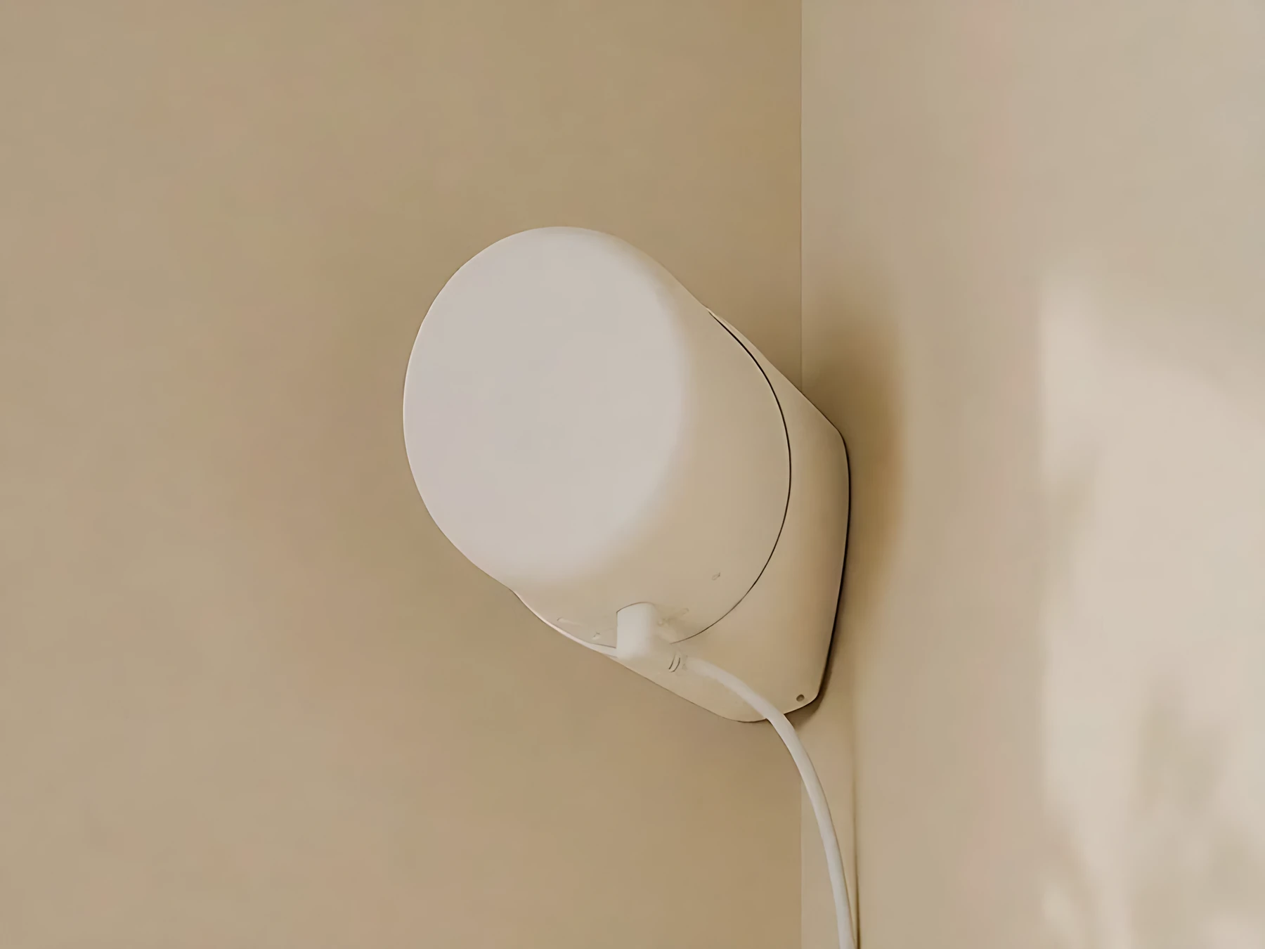 The sensor mounted in a room corner.